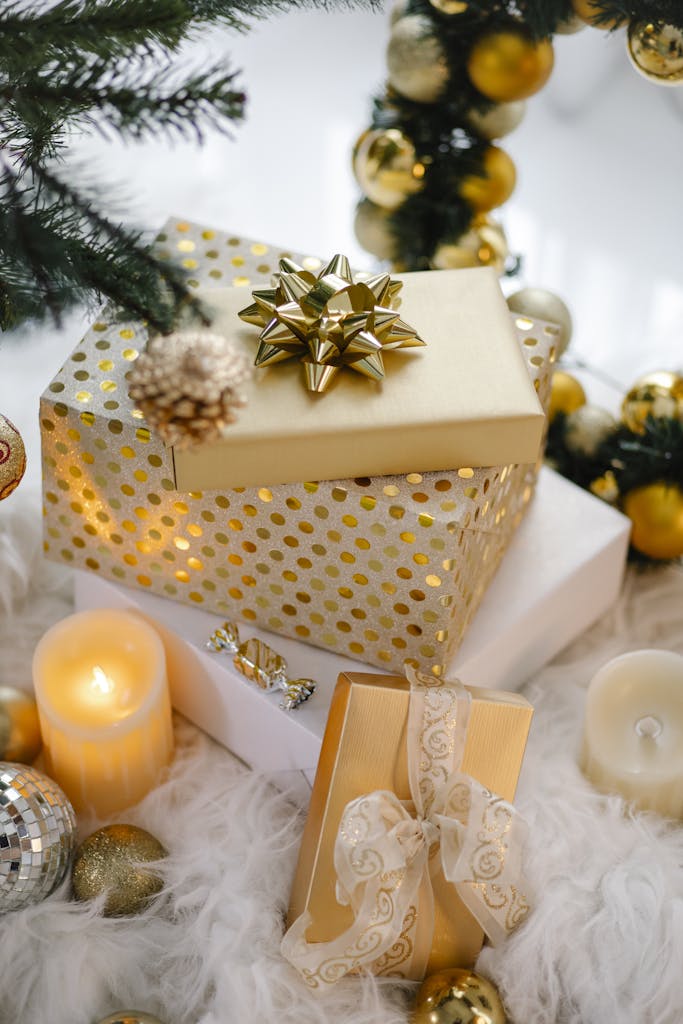 Colorful gift boxes and candle under Christmas tree